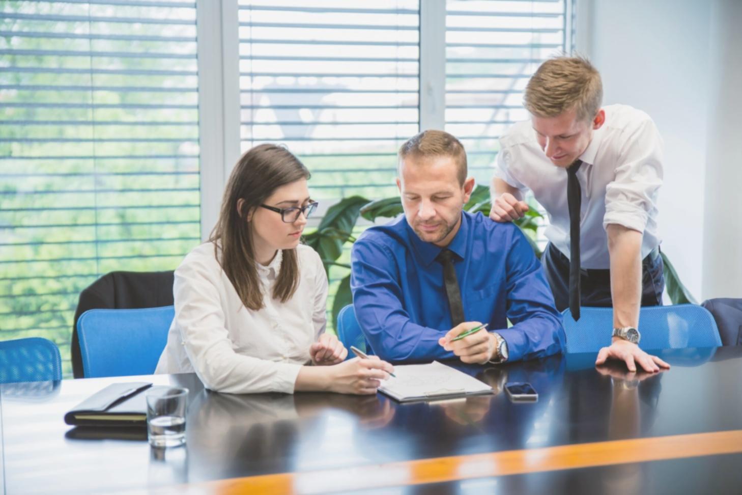 Financial analysis team reviewing industry market data and trends